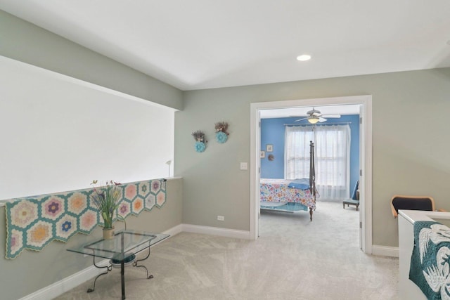 interior space featuring recessed lighting, light colored carpet, and baseboards