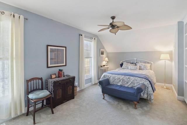 bedroom featuring baseboards, lofted ceiling, light colored carpet, and a ceiling fan