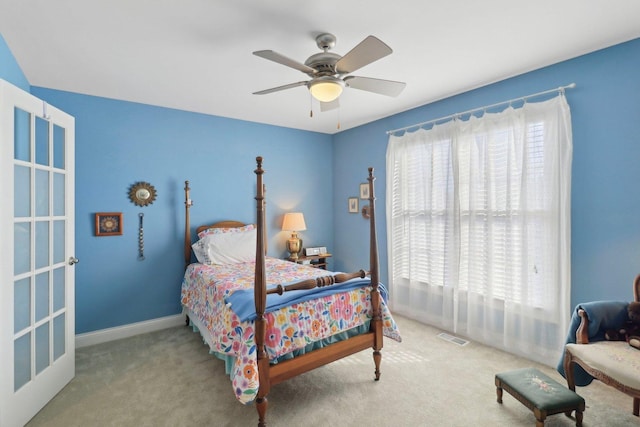 bedroom with visible vents, ceiling fan, baseboards, and carpet