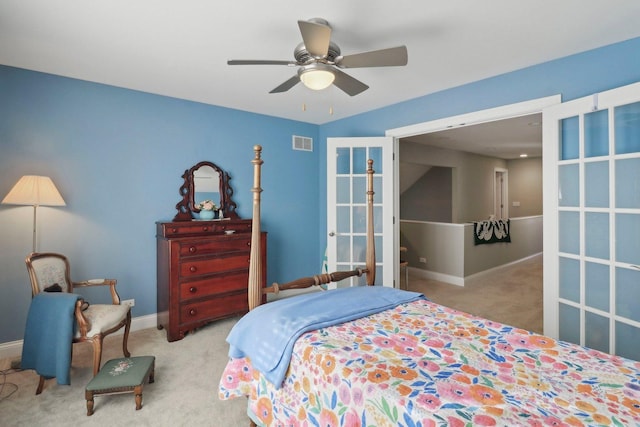 carpeted bedroom featuring visible vents, baseboards, and a ceiling fan