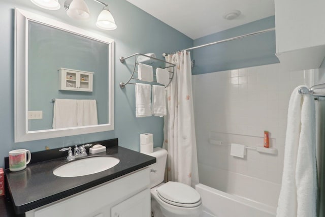 bathroom with vanity, toilet, and shower / bath combo with shower curtain