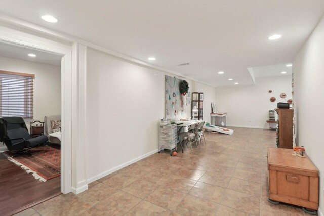 hallway featuring light tile patterned floors, recessed lighting, and baseboards