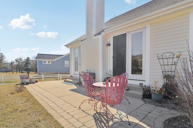 view of patio / terrace featuring entry steps and fence