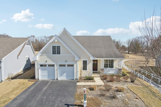 view of front of property featuring aphalt driveway and a porch