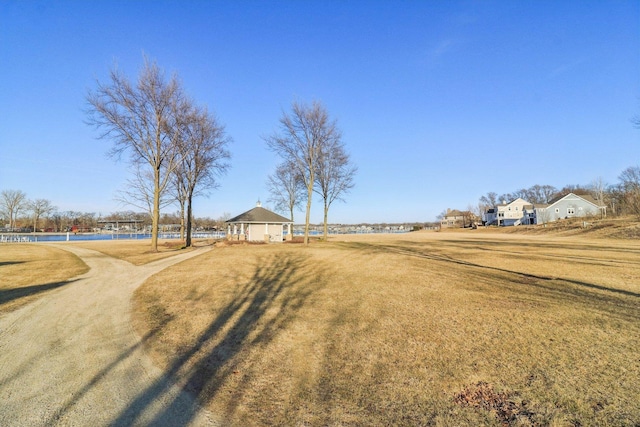 view of home's community with a yard and a water view