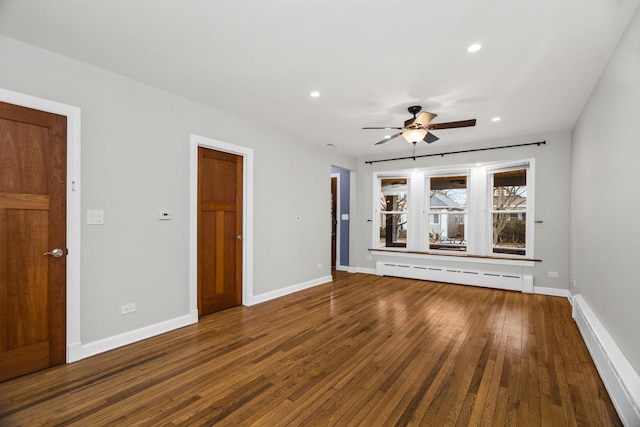 spare room with ceiling fan, a baseboard radiator, hardwood / wood-style flooring, recessed lighting, and baseboards