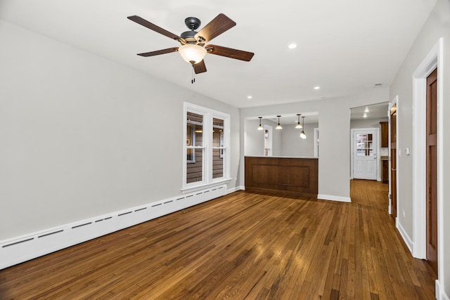 unfurnished living room featuring baseboards, ceiling fan, wood-type flooring, baseboard heating, and recessed lighting