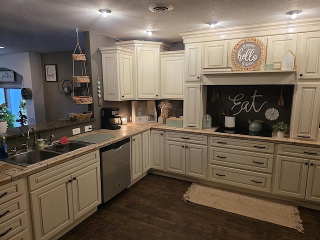 kitchen with visible vents, dark wood finished floors, light countertops, stainless steel dishwasher, and a sink