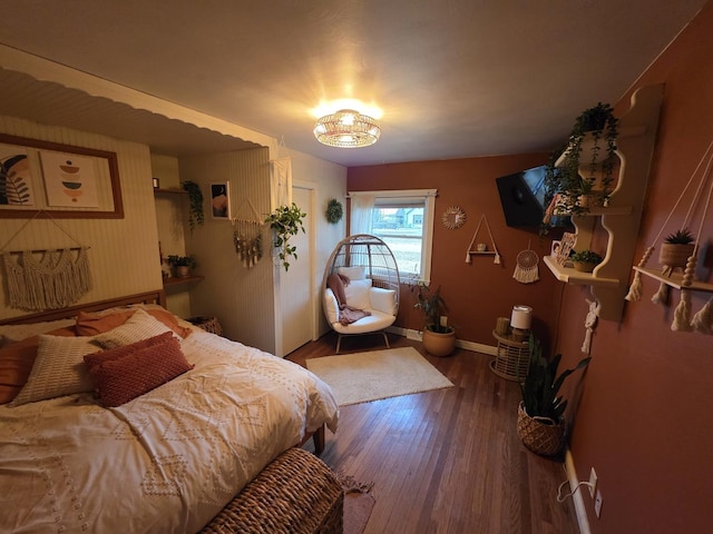 bedroom with wood finished floors and baseboards