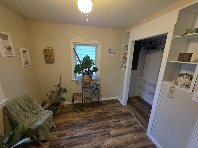 living area with dark wood finished floors and baseboards