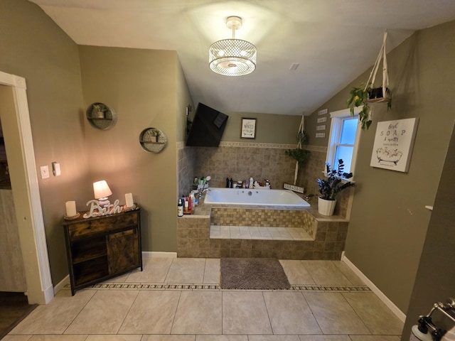 bathroom featuring lofted ceiling, a garden tub, and tile patterned floors