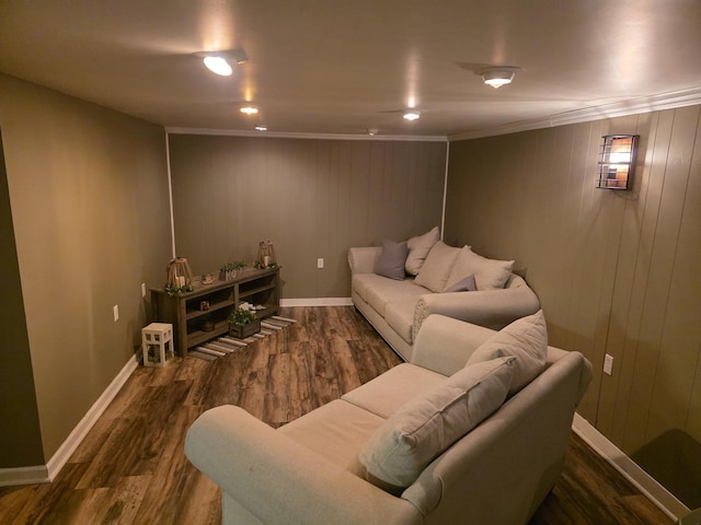 living room with crown molding, baseboards, and wood finished floors