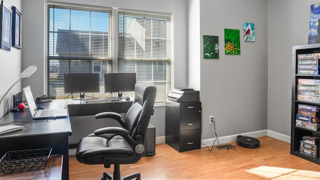 office area with baseboards and wood finished floors