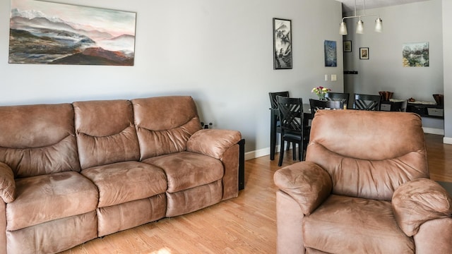 living room with baseboards and light wood-style flooring