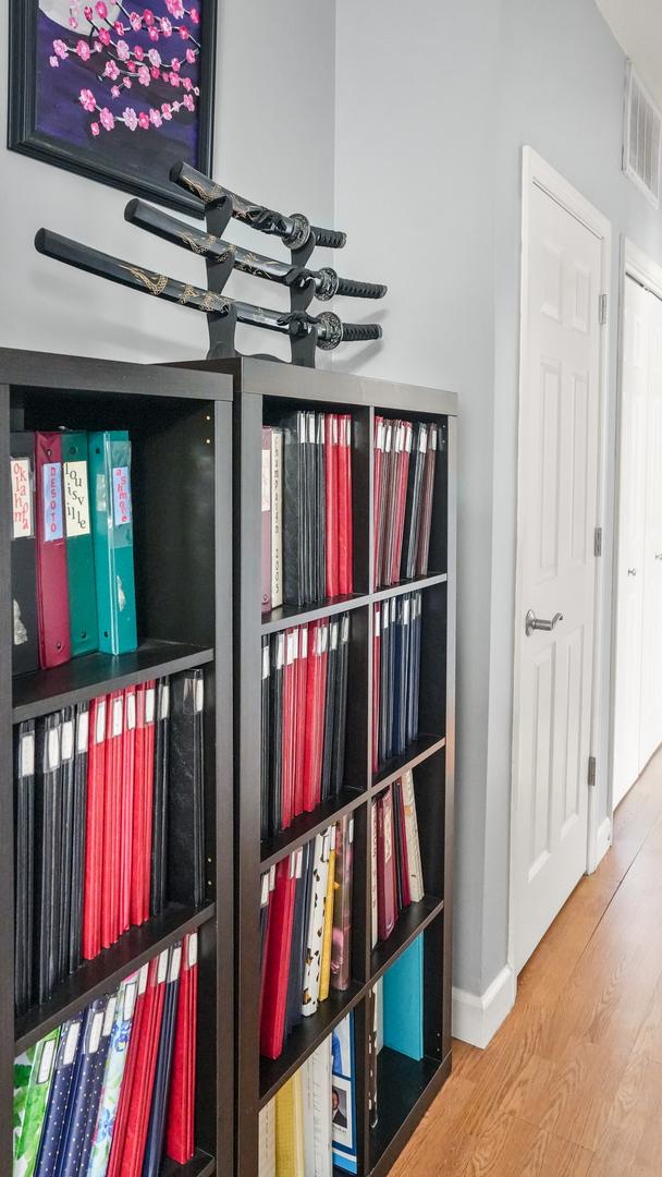 details with wood finished floors, visible vents, and baseboards