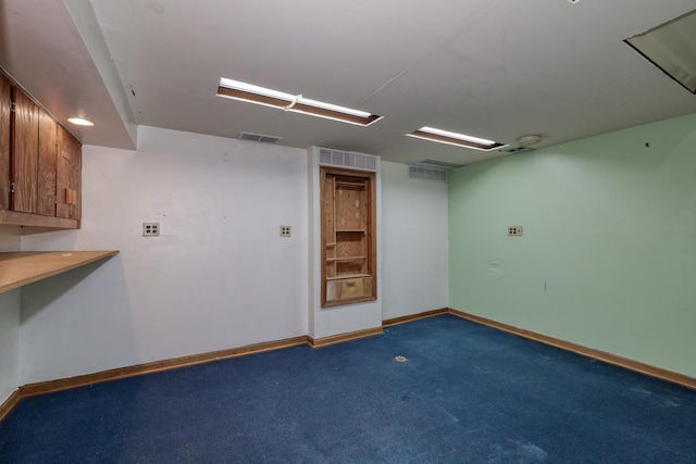 empty room with carpet, baseboards, and visible vents