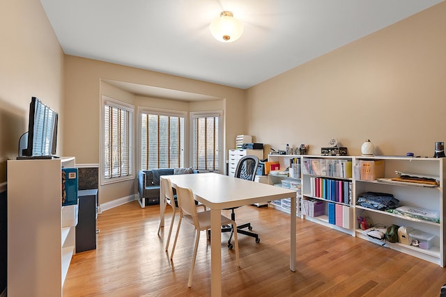 home office featuring light wood finished floors and baseboards