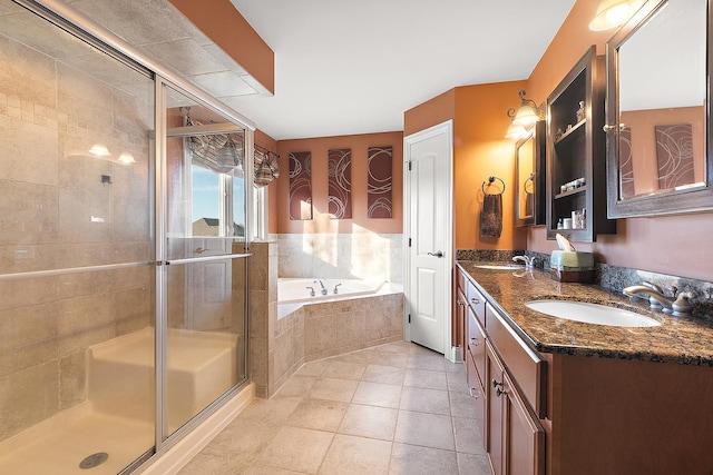 full bathroom with double vanity, a stall shower, a garden tub, tile patterned flooring, and a sink