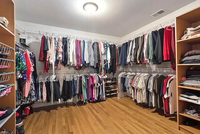 walk in closet featuring visible vents and wood finished floors