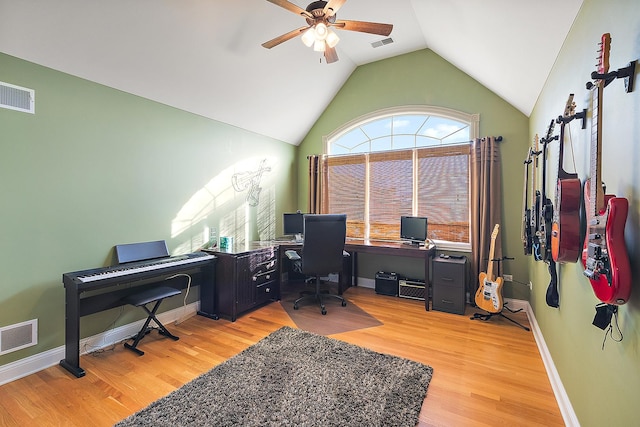 office area with lofted ceiling, light wood-type flooring, and visible vents