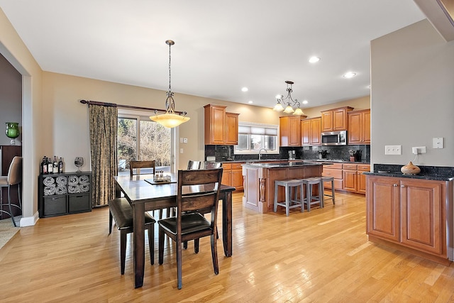 dining area featuring light wood finished floors and recessed lighting