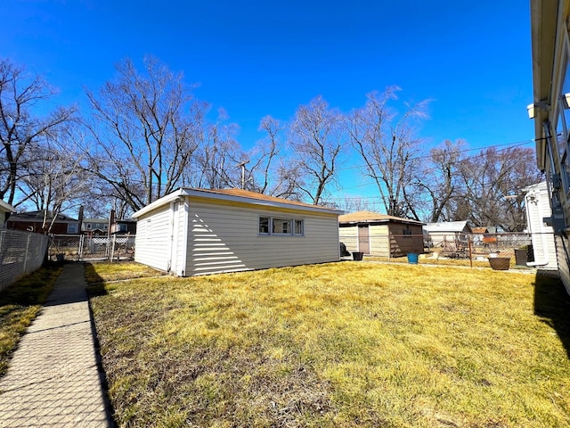 view of yard with fence and an outdoor structure