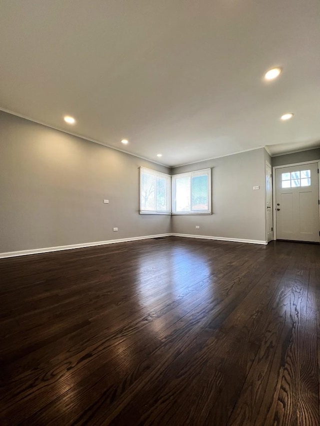 interior space with dark wood-type flooring, recessed lighting, and baseboards