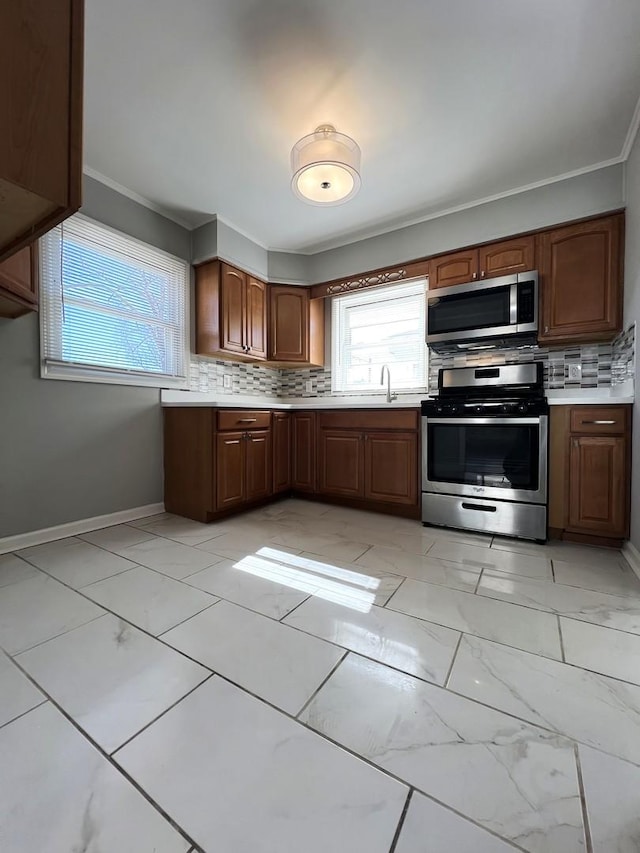 kitchen featuring appliances with stainless steel finishes, marble finish floor, and light countertops