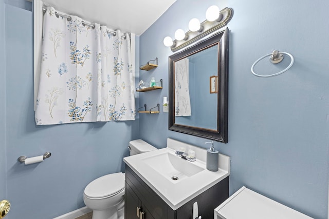 bathroom with toilet and vanity