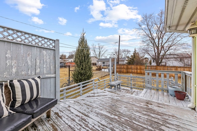 wooden terrace featuring a fenced backyard