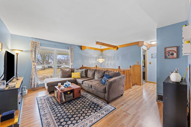 living room featuring light wood-type flooring and baseboards