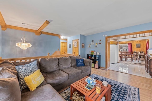 living room with an inviting chandelier and wood finished floors