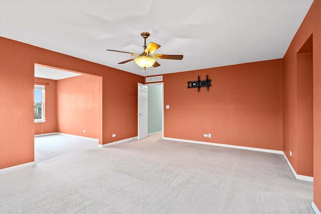 unfurnished room with light carpet, a ceiling fan, and baseboards