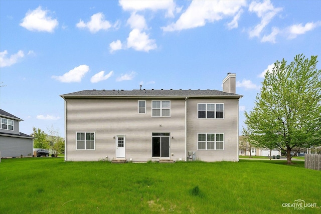 117 Preakness Dr, Oswego, IL 60543 - rear view of property with entry steps, a chimney, and a yard