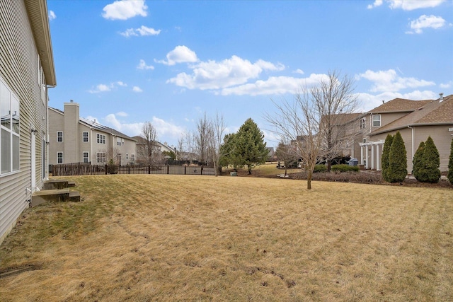 view of yard with a residential view and fence