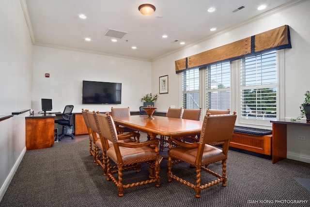 dining space featuring ornamental molding, dark colored carpet, visible vents, and baseboards