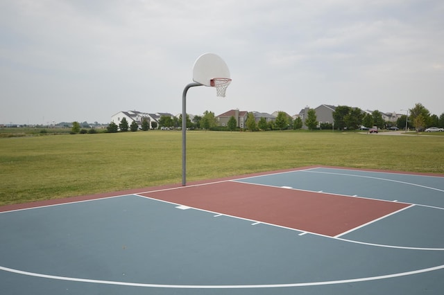 view of basketball court with community basketball court and a lawn