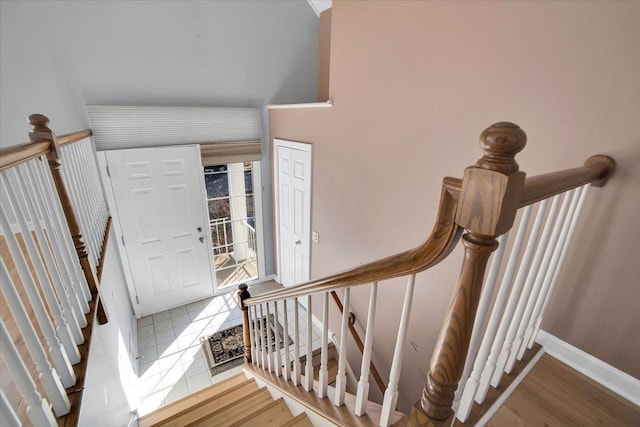 stairway with baseboards and wood finished floors