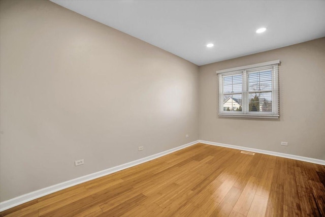 spare room with light wood-style floors, recessed lighting, and baseboards