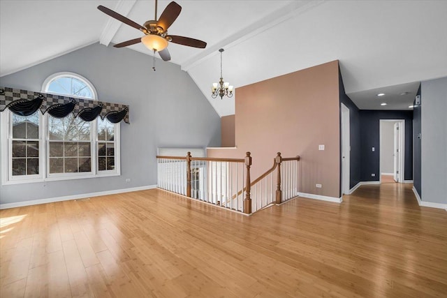 spare room with baseboards, high vaulted ceiling, wood finished floors, and beamed ceiling