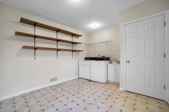 laundry area featuring cabinet space, visible vents, baseboards, washer and clothes dryer, and light floors