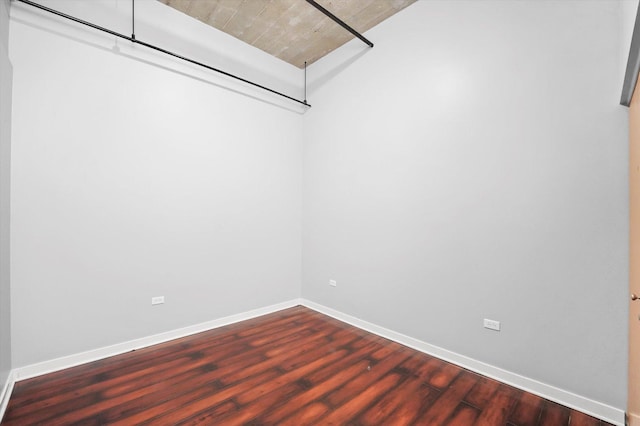 spacious closet with dark wood-style flooring