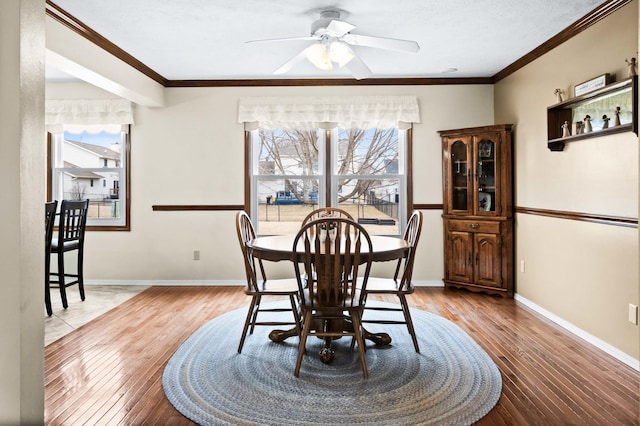 dining space with a healthy amount of sunlight, hardwood / wood-style flooring, and crown molding