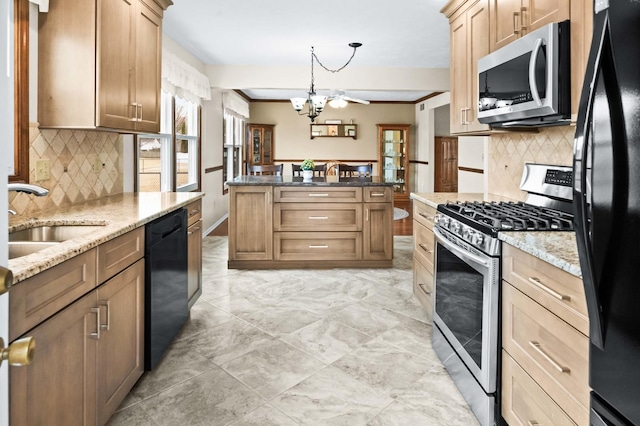 kitchen featuring a chandelier, light stone counters, a sink, black appliances, and decorative light fixtures