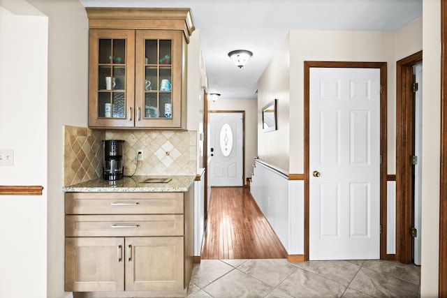 interior space with decorative backsplash and light tile patterned floors