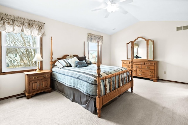 bedroom featuring vaulted ceiling, visible vents, and light colored carpet