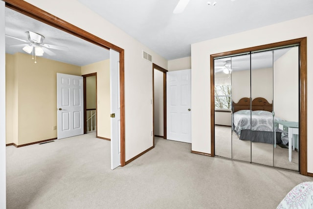 bedroom with carpet, a closet, visible vents, ceiling fan, and baseboards