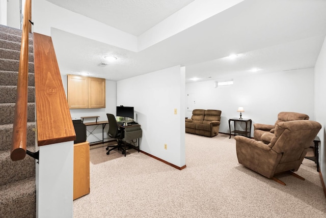 office featuring light carpet, baseboards, and a textured ceiling