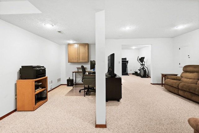 office area with baseboards, visible vents, and a textured ceiling