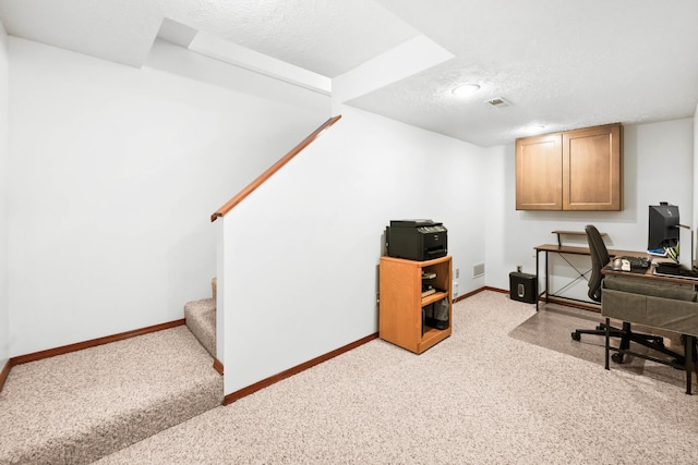 office with visible vents, baseboards, and a textured ceiling